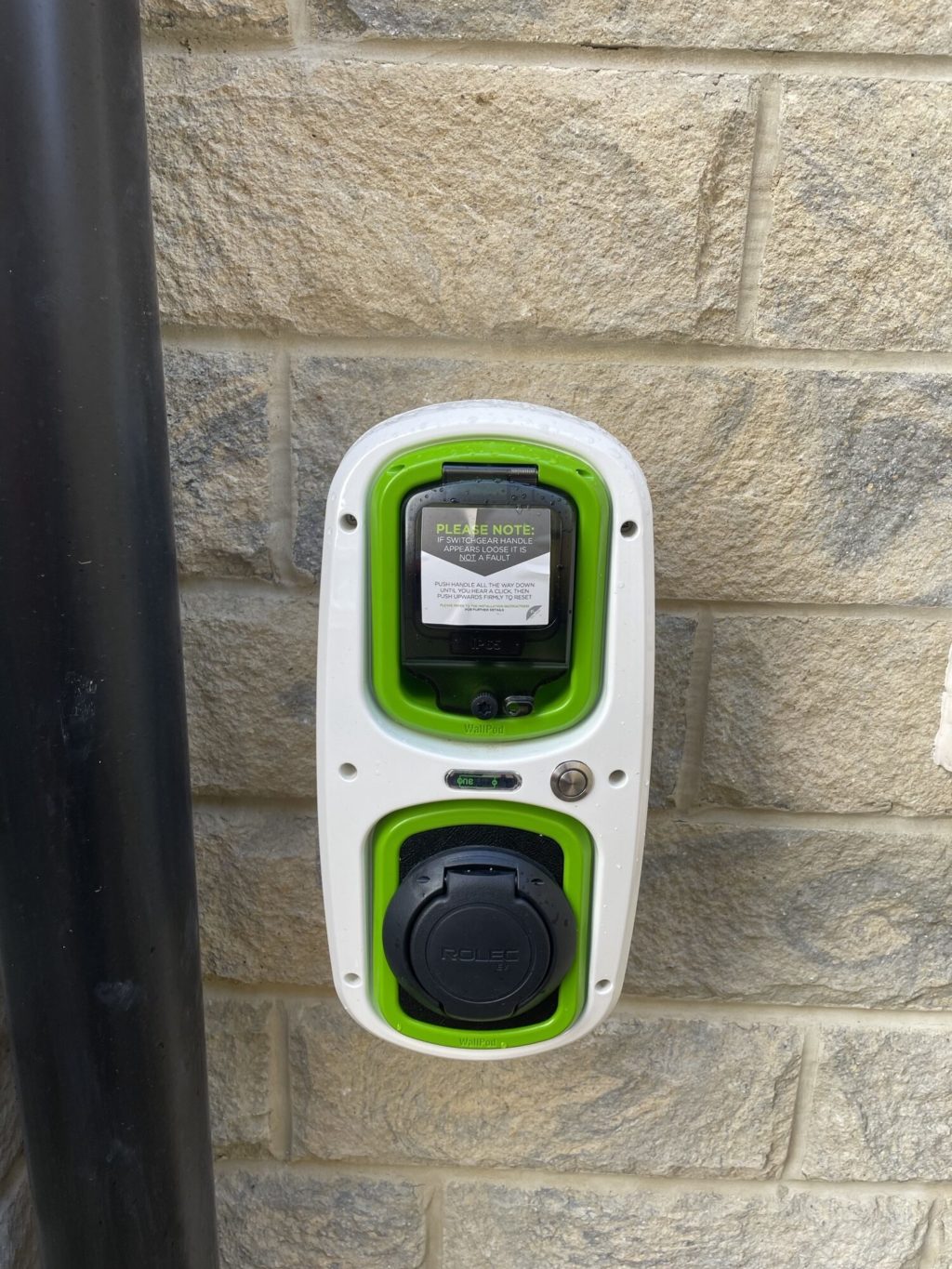 Electric car charger installed on a house wall