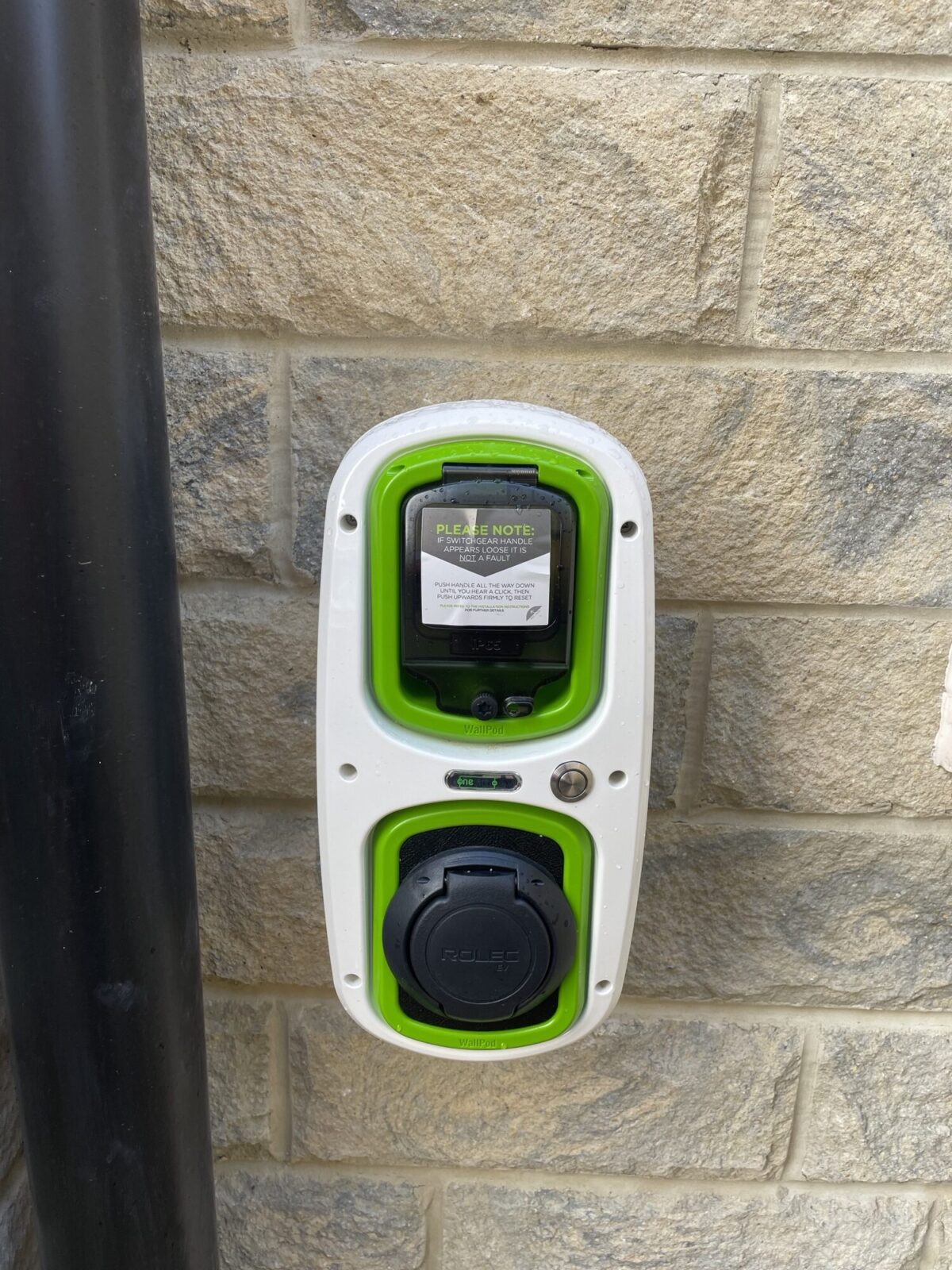 Electric car charger installed on a house wall