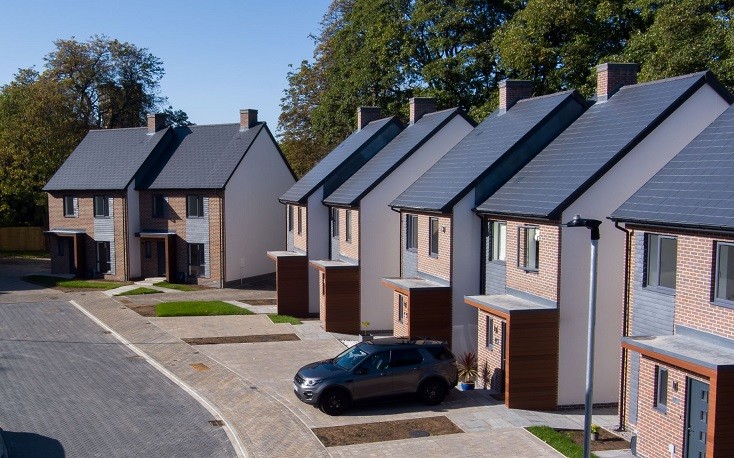 Semi detached new builds with a car parked outside one of them