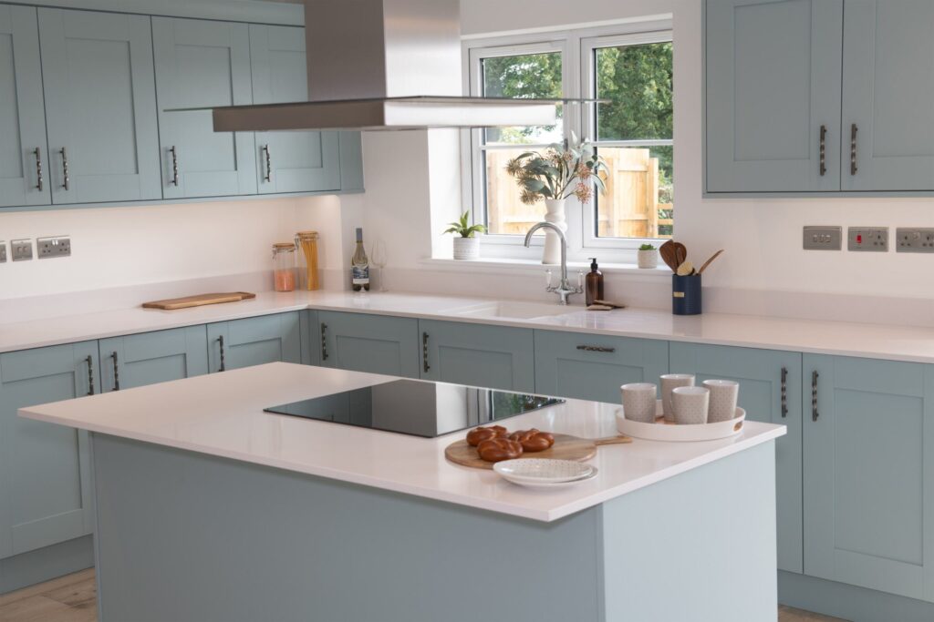 completed kitchen with blue cabinets and white counter tops