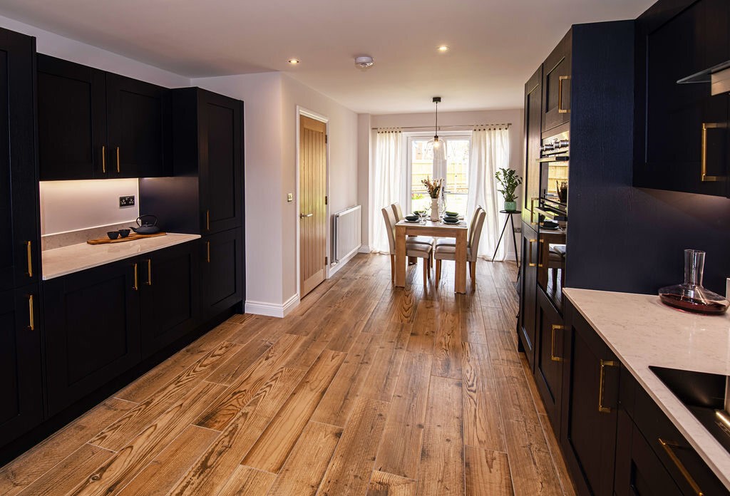 completed kitchen in new build with dark blue cabinets and white counter tops